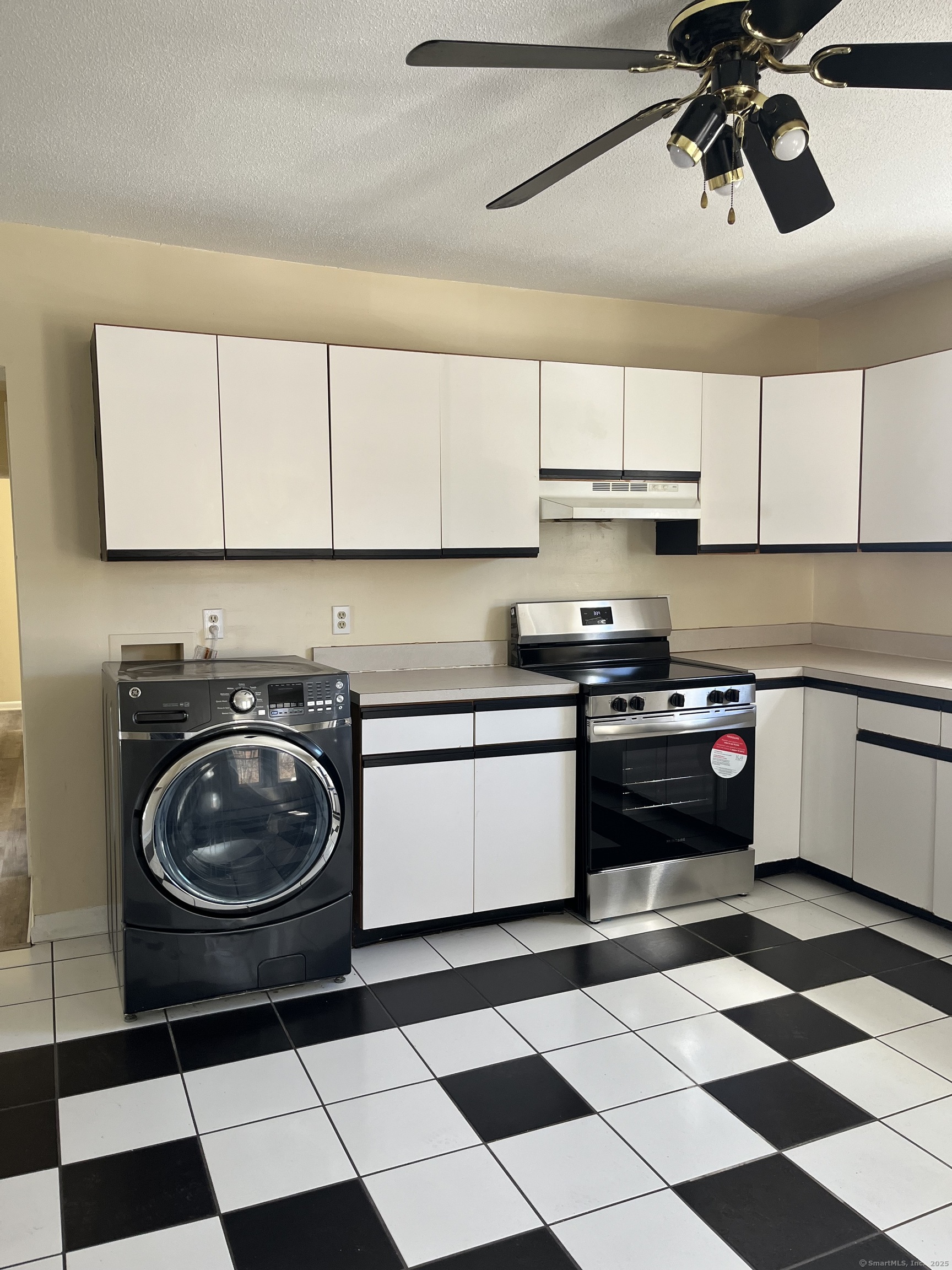 61 School Street Naugatuck, CT 06770 - Photo 4 of 6 a kitchen with a stove a sink and cabinets
