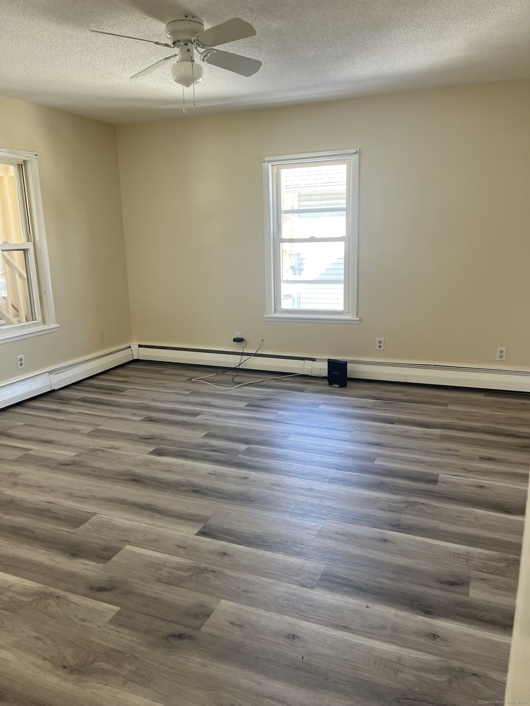 61 School Street Naugatuck, CT 06770 - Photo 5 of 6 an empty room with wooden floor and windows