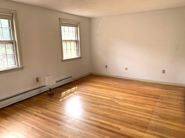 72 Bailey Lane Georgetown, MA 01833 - Photo 13 of 29 an empty room with wooden floor and windows