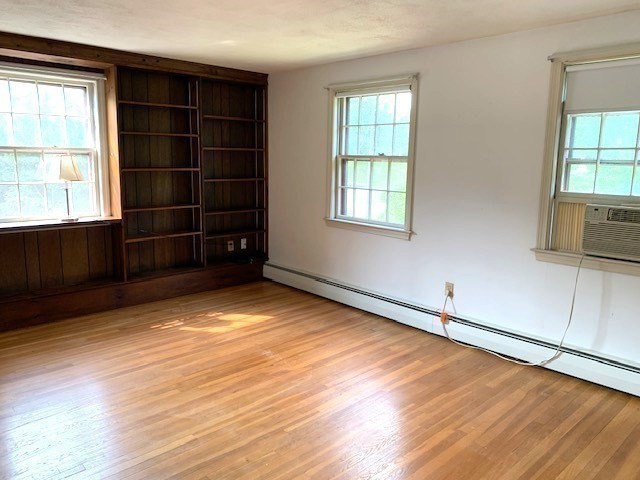 72 Bailey Lane Georgetown, MA 01833 - Photo 19 of 29 an empty room with wooden floor and windows