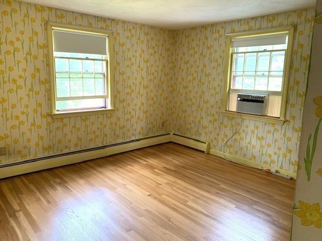 72 Bailey Lane Georgetown, MA 01833 - Photo 21 of 29 a view of an empty room with wooden floor and a window