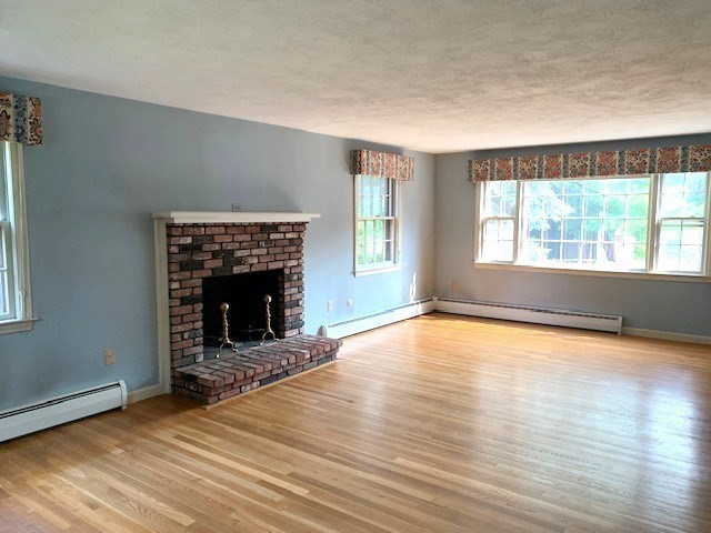 72 Bailey Lane Georgetown, MA 01833 - Photo 3 of 29 an empty room with windows and fireplace