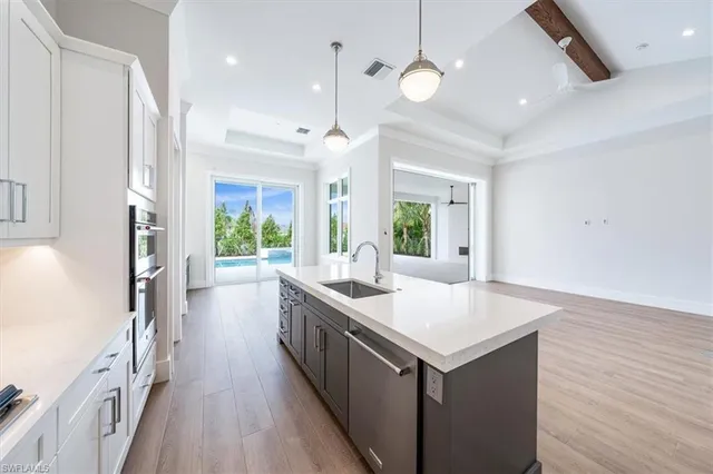 a kitchen with a stove and a wooden floor