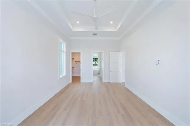 an empty room with closet and windows
