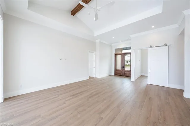 a view of an empty room with wooden floor