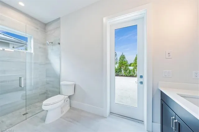 a bathroom with a toilet a sink and shower