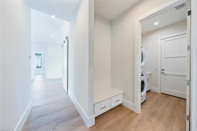 a view of a hallway with wooden floor