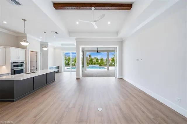 a large space with a lot of counter space and wooden floor