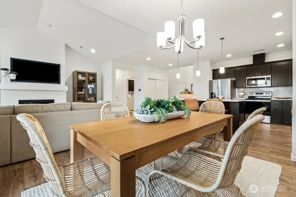 a view of a dining room with furniture and a flat screen tv