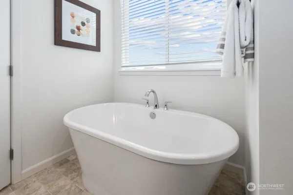 a white and white tub sitting in a bathroom