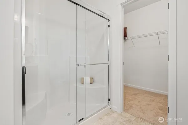 a bathroom with a glass shower door
