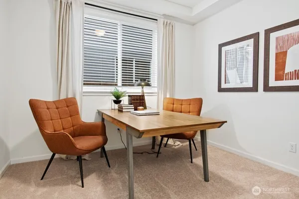 a view of a workspace with a window and a table in a room