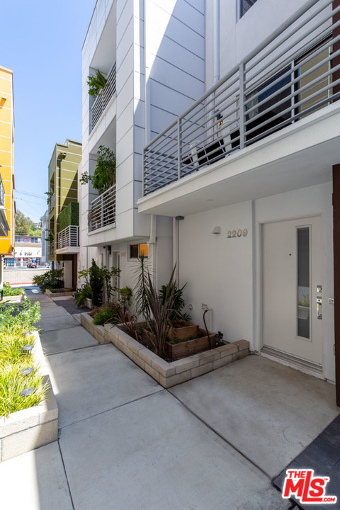 2209 Polyscope Place Los Angeles, CA 90026 - Photo 2 of 37 a front view of a building with potted plants