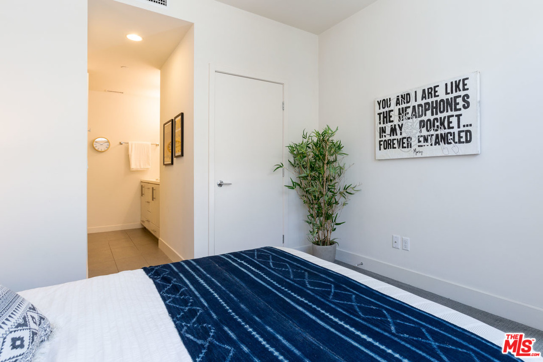 2209 Polyscope Place Los Angeles, CA 90026 - Photo 23 of 37 a bedroom with a bed and a potted plant