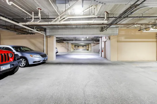 a view of parking garage with cars