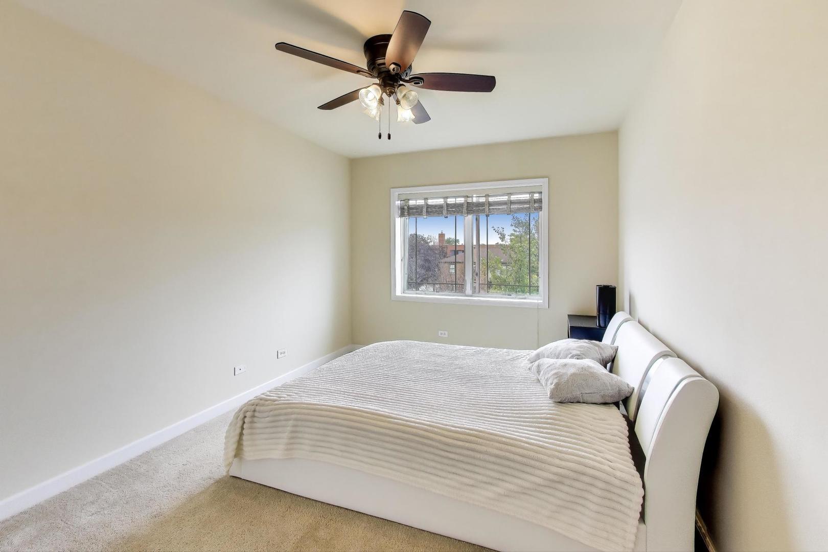 77 North Wolf Road, Unit 312 Melrose Park, IL 60164 - Photo 10 of 20 a bedroom with a bed and a window