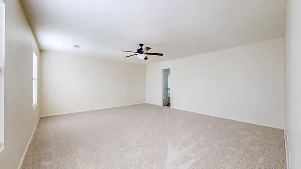 a view of a room with a ceiling fan