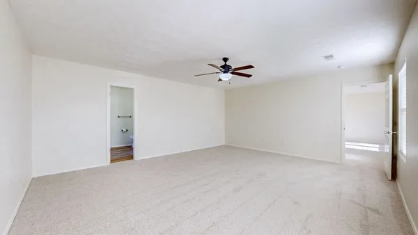 a view of an empty room with a fan