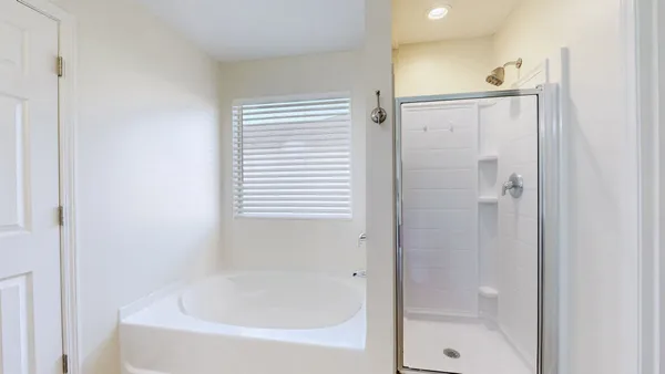 a bathroom with a bathtub and shower