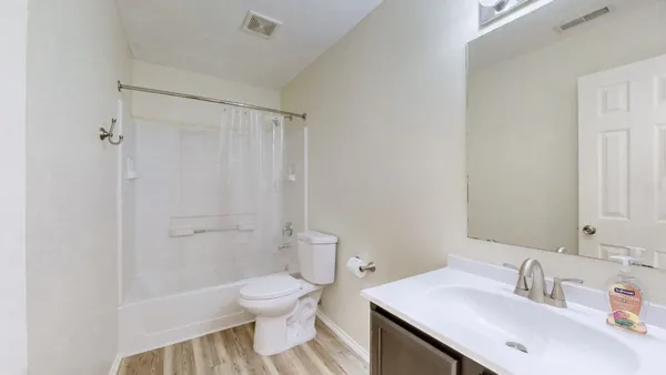 a bathroom with a sink toilet and shower