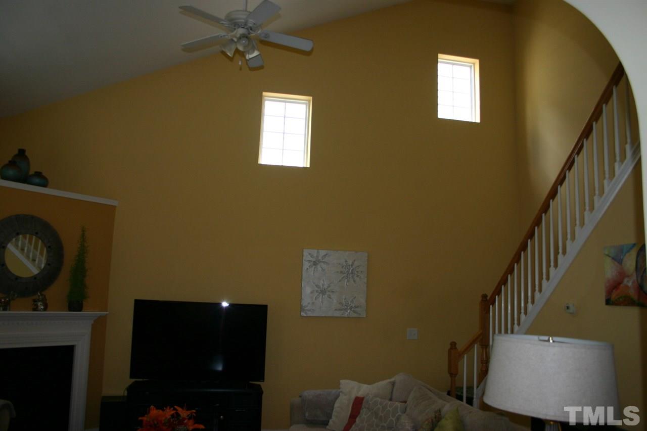 8207 Beaded Stone Street Raleigh, NC 27613 - Photo 13 of 23 a view of entryway and hall with wooden floor