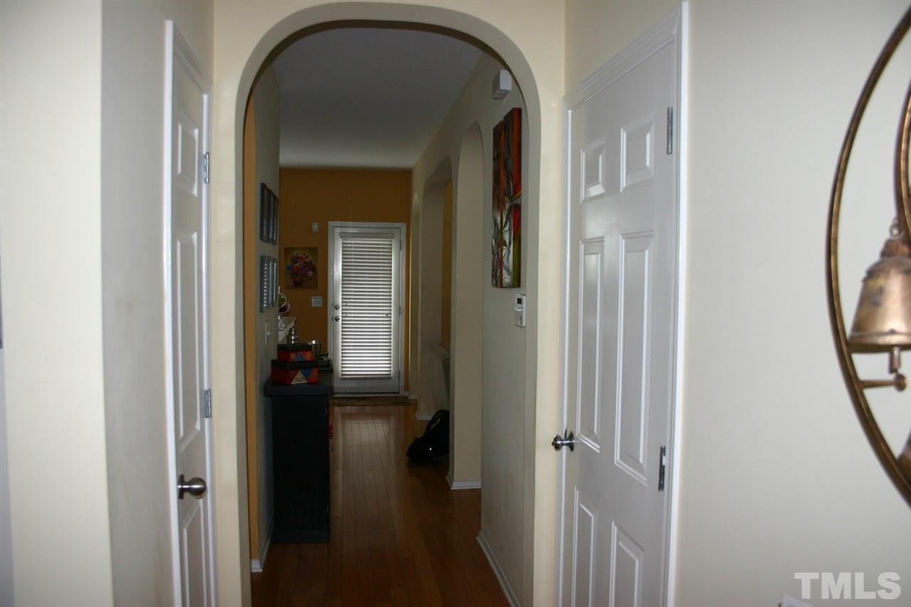 8207 Beaded Stone Street Raleigh, NC 27613 - Photo 8 of 23 a view of a livingroom from a hallway