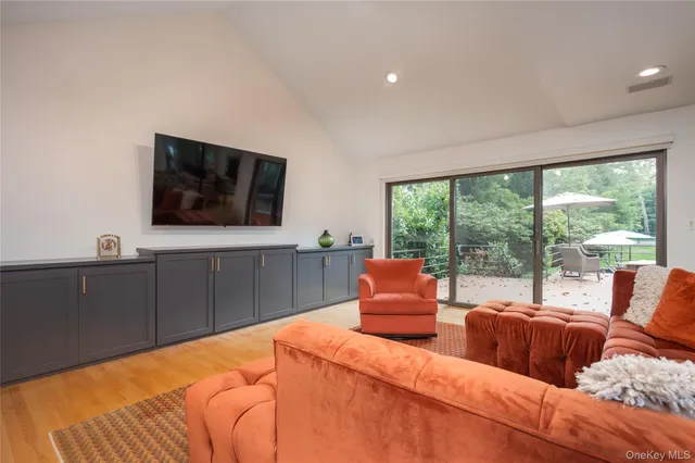 a bedroom with furniture and a flat screen tv