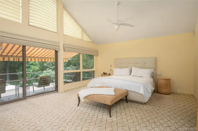 a bedroom with a bed and a large window