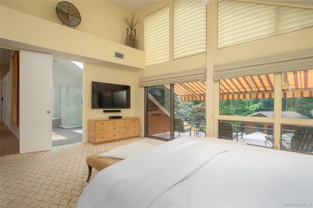 a living room with a large window and a flat screen tv