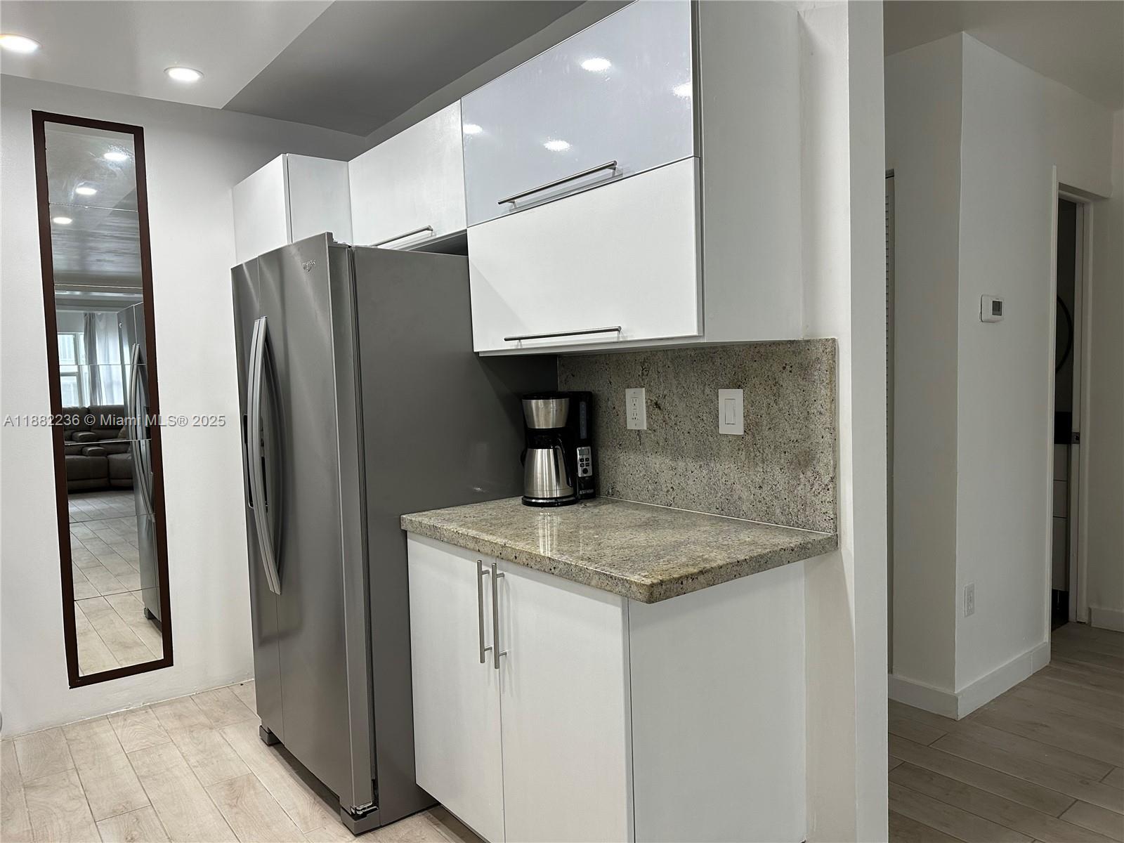 1130 11th Street, Unit 4D Miami Beach, FL 33139 - Photo 12 of 23 a kitchen with stainless steel appliances granite countertop a refrigerator and a sink