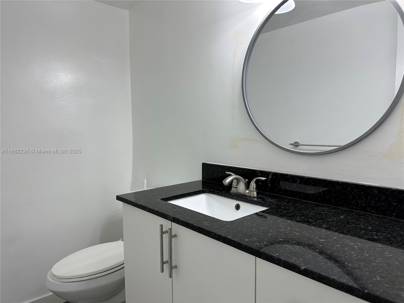 1130 11th Street, Unit 4D Miami Beach, FL 33139 - Photo 17 of 23 a bathroom with a sink and a mirror