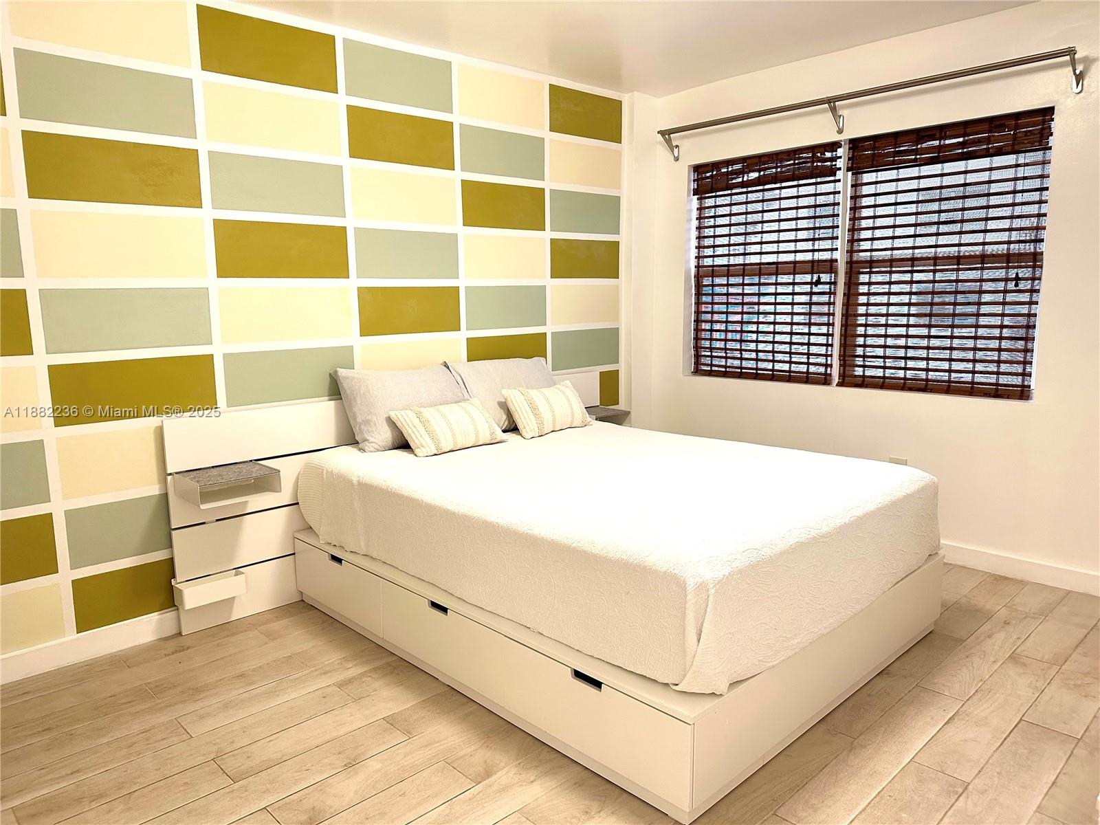 1130 11th Street, Unit 4D Miami Beach, FL 33139 - Photo 6 of 23 a large white bed in a small room next to a window