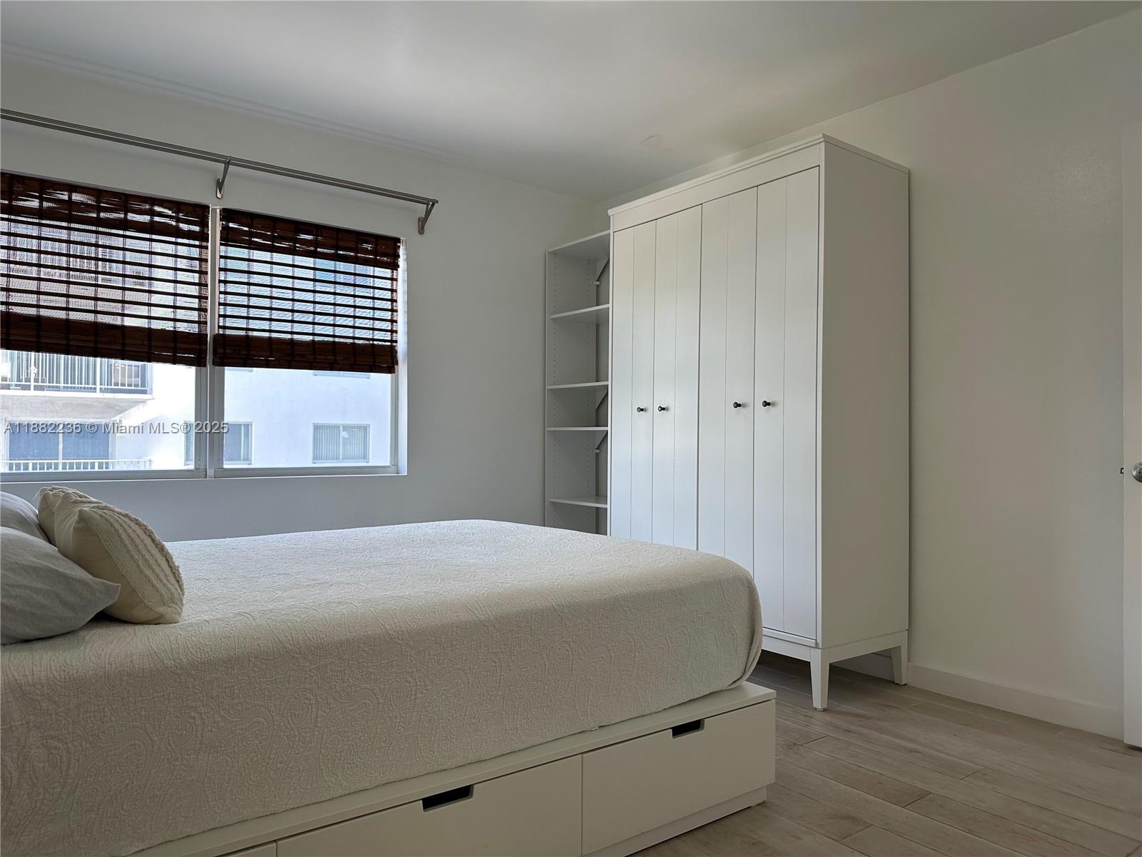 1130 11th Street, Unit 4D Miami Beach, FL 33139 - Photo 8 of 23 a bedroom with a bed and a window