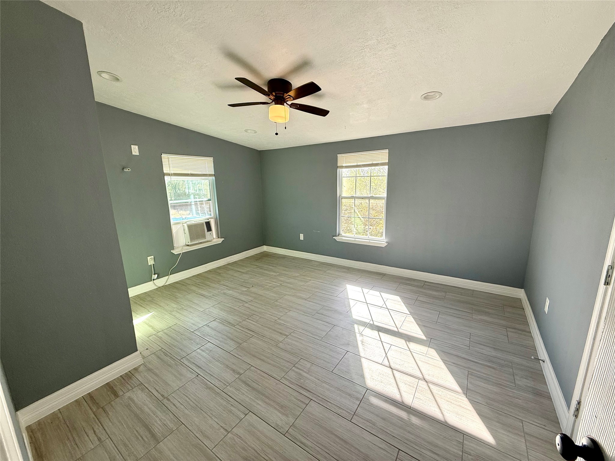 9015 Puritan Way Rosharon, TX 77583 - Photo 11 of 16 wooden floor in an empty room with a window