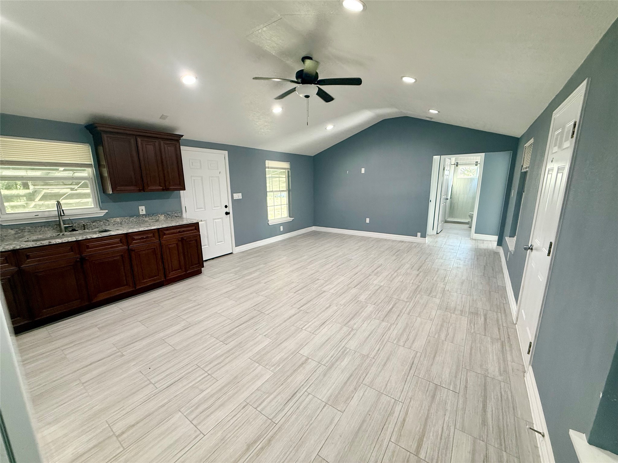 9015 Puritan Way Rosharon, TX 77583 - Photo 2 of 16 wooden floor in an empty room with a kitchen