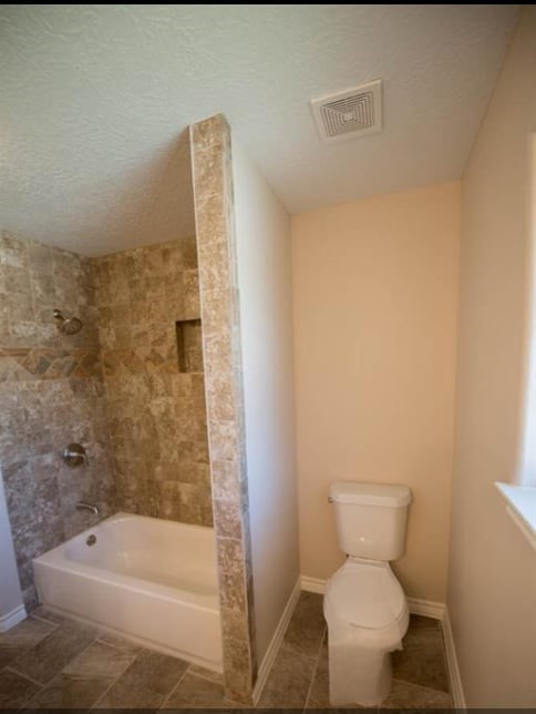 8419 Dover Street Houston, TX 77061 - Photo 11 of 15 a bathroom with a toilet and bathtub