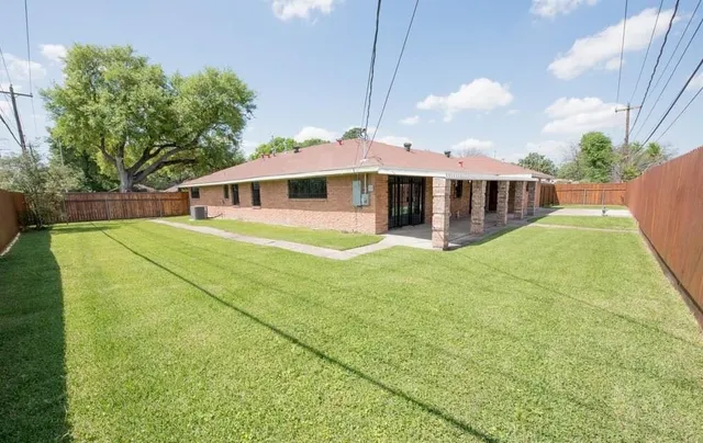 a view of a house with pool and garden
