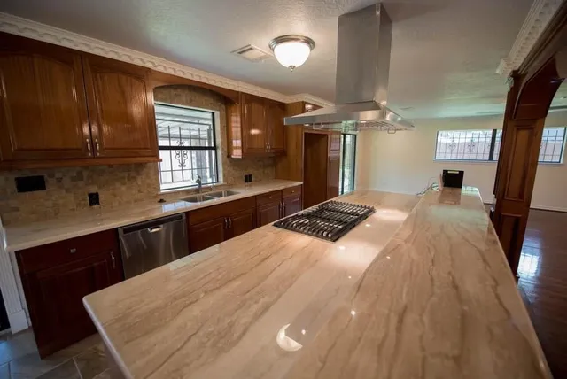 a kitchen with a sink appliances and cabinets