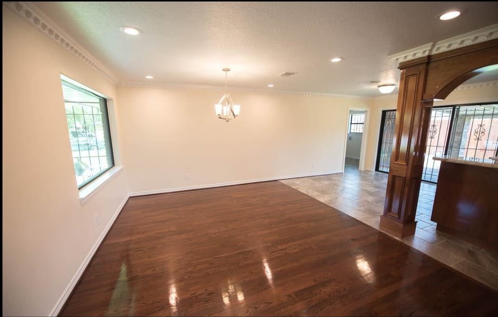 8419 Dover Street Houston, TX 77061 - Photo 9 of 15 a view of an empty room with wooden floor and a window