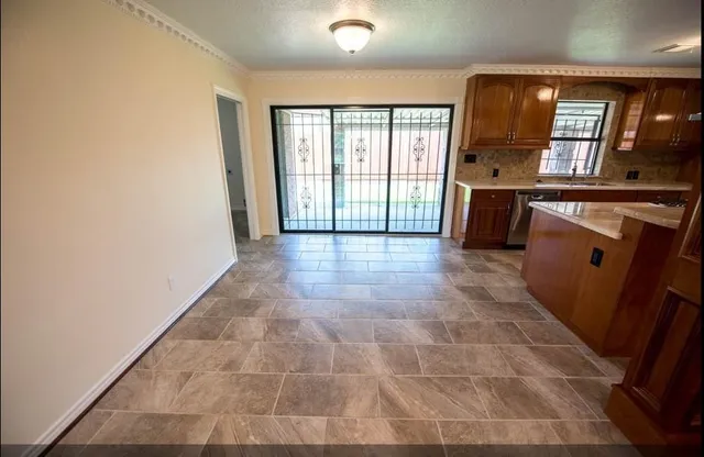 an empty room with windows and entrance