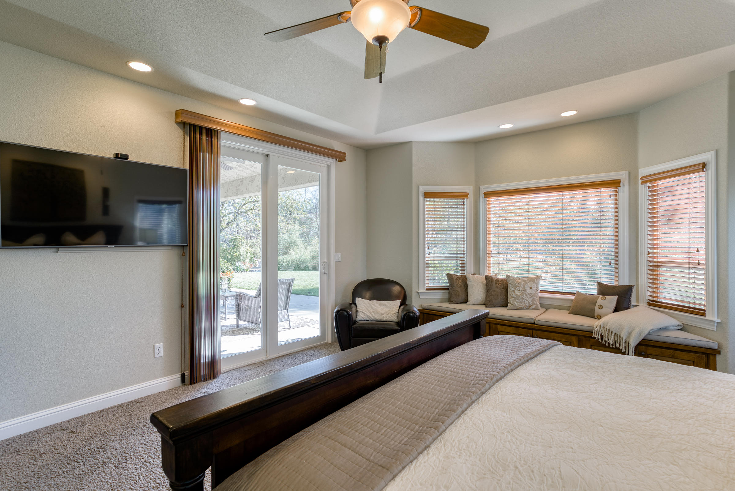 10163 Tilton Mine Road Redding, CA 96001 - Photo 15 of 144 a bedroom with a large bed and a large window
