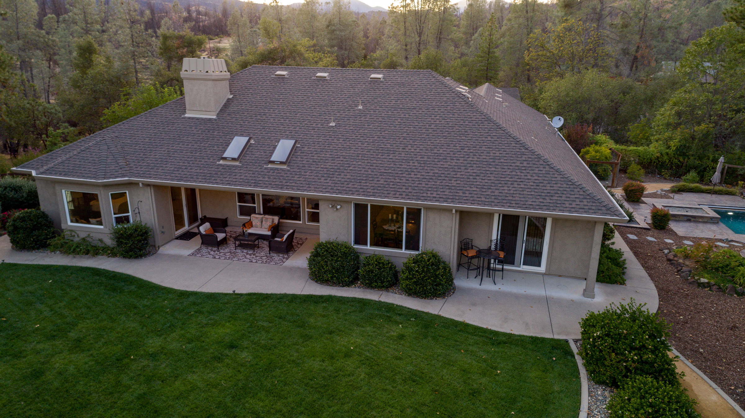 10163 Tilton Mine Road Redding, CA 96001 - Photo 37 of 144 a aerial view of a house with table and chairs potted plants and a yard