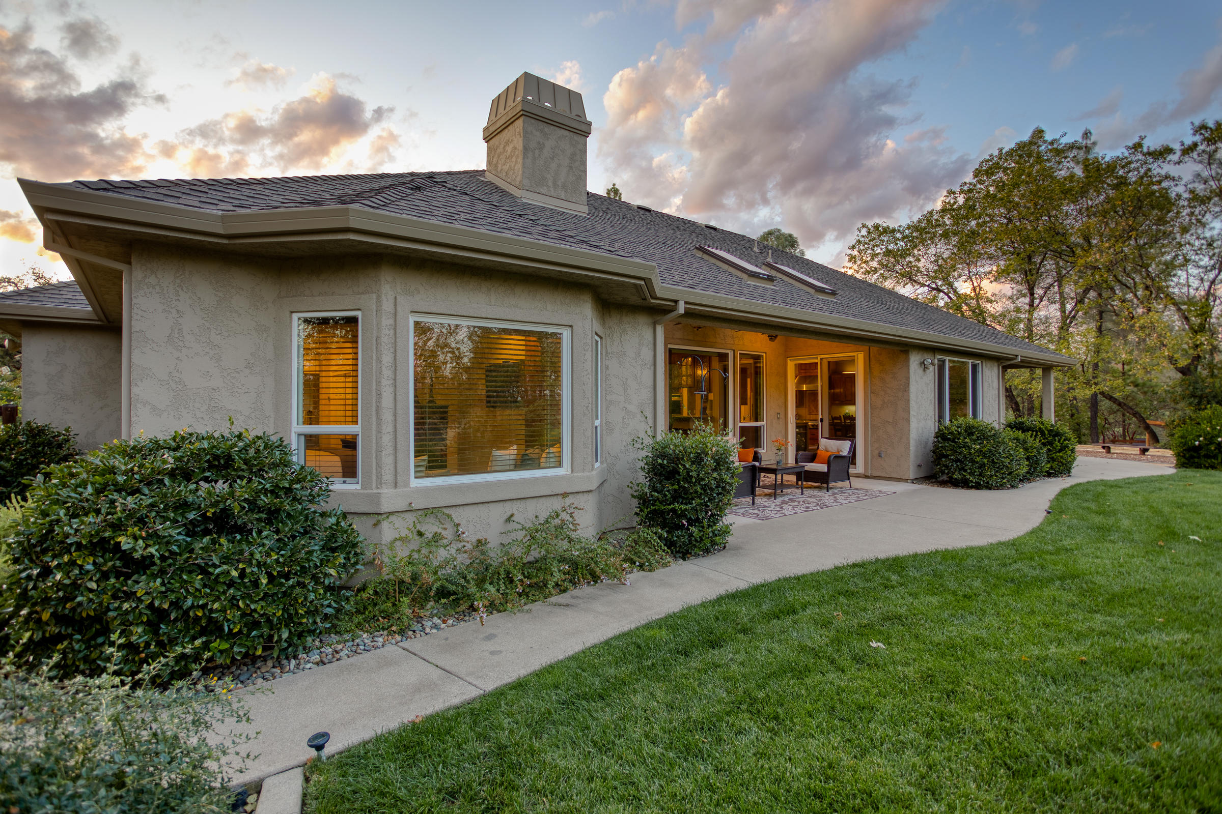10163 Tilton Mine Road Redding, CA 96001 - Photo 46 of 144 a front view of a house with porch and garden