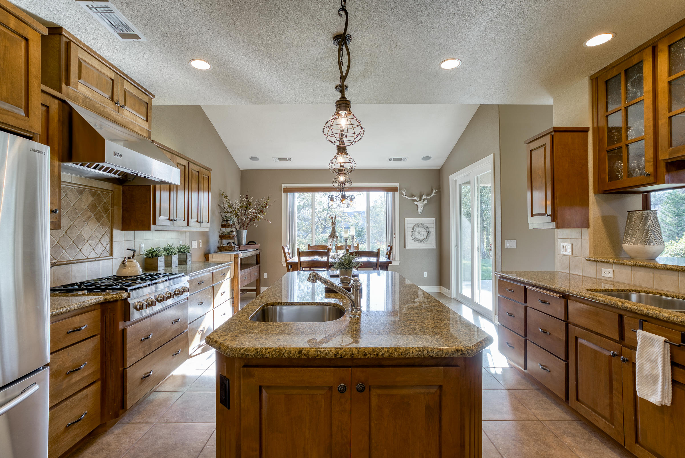10163 Tilton Mine Road Redding, CA 96001 - Photo 5 of 144 a kitchen with stainless steel appliances granite countertop a sink stove and refrigerator