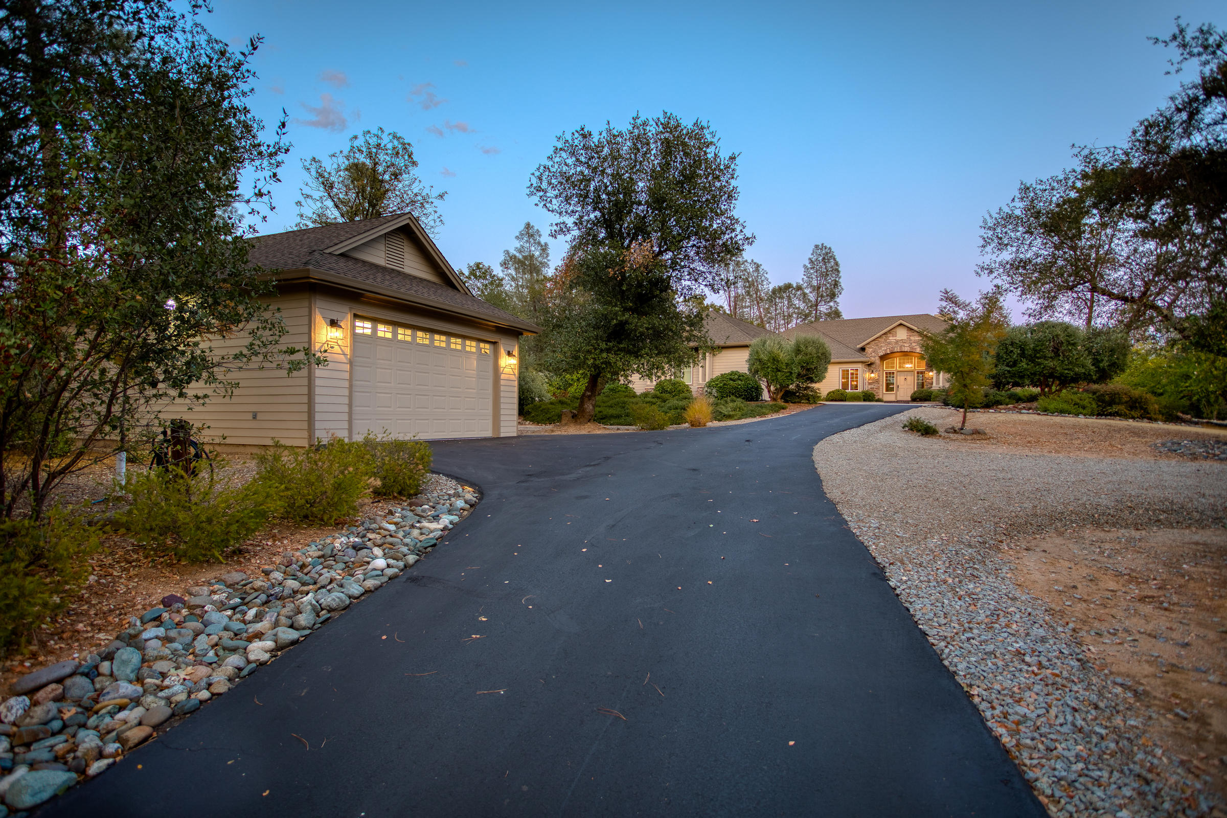 10163 Tilton Mine Road Redding, CA 96001 - Photo 51 of 144 a front view of a house with a yard and garage