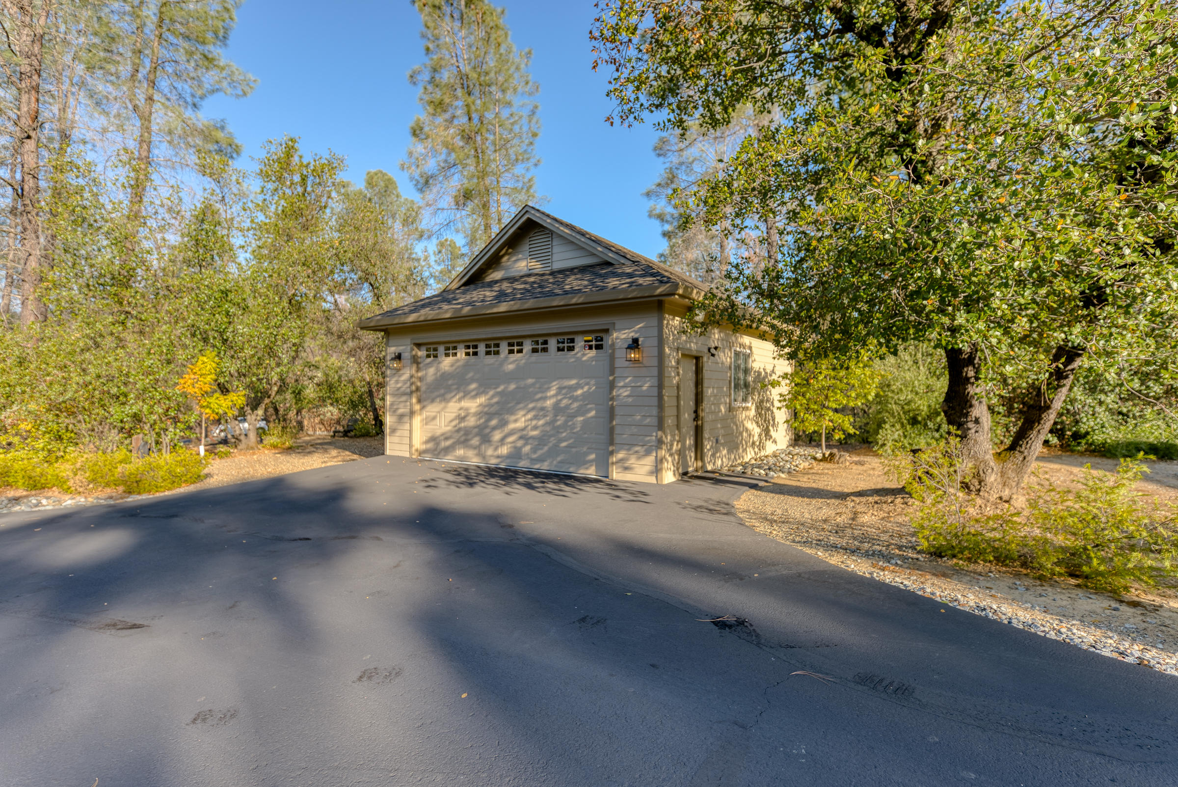 10163 Tilton Mine Road Redding, CA 96001 - Photo 57 of 144 a front view of a house with a yard and garage