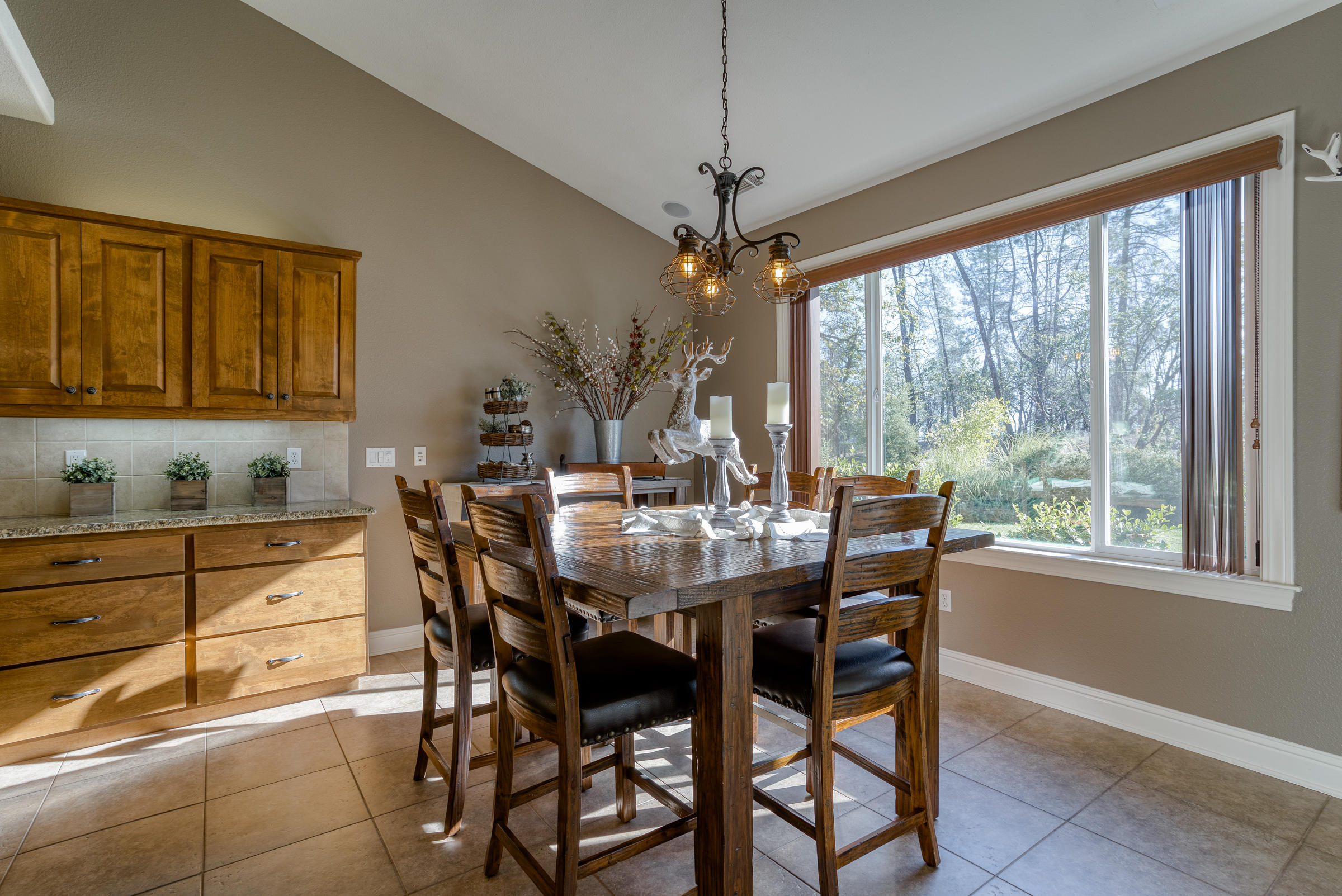 10163 Tilton Mine Road Redding, CA 96001 - Photo 65 of 144 a view of a dining room with furniture window and outside view