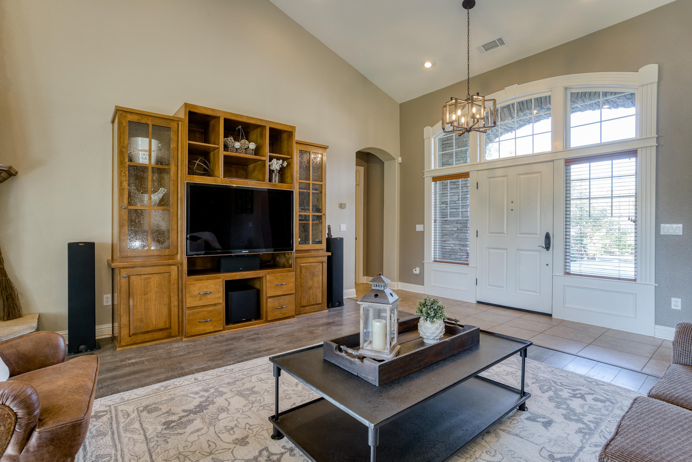 10163 Tilton Mine Road Redding, CA 96001 - Photo 69 of 144 a living room with furniture a flat screen tv and a chandelier