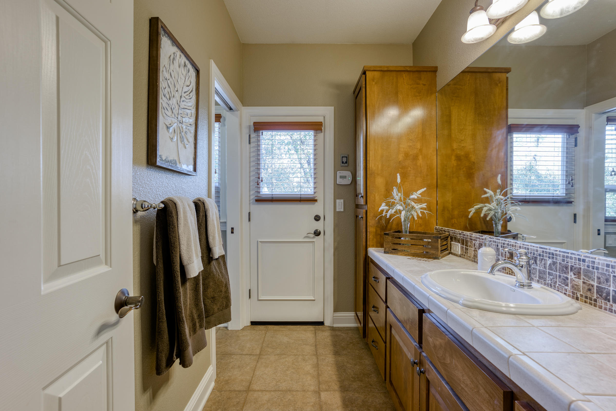 10163 Tilton Mine Road Redding, CA 96001 - Photo 92 of 144 a bathroom with a sink a mirror and a shower