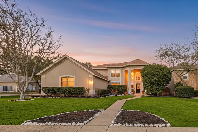 a front view of a house with a yard